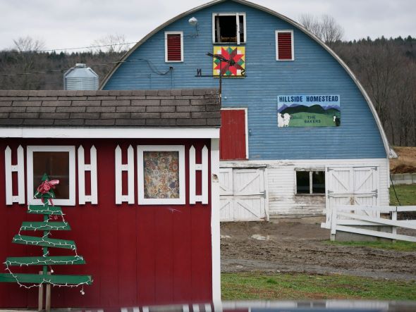 Red barn in lower right foreground with blue and white barn in background