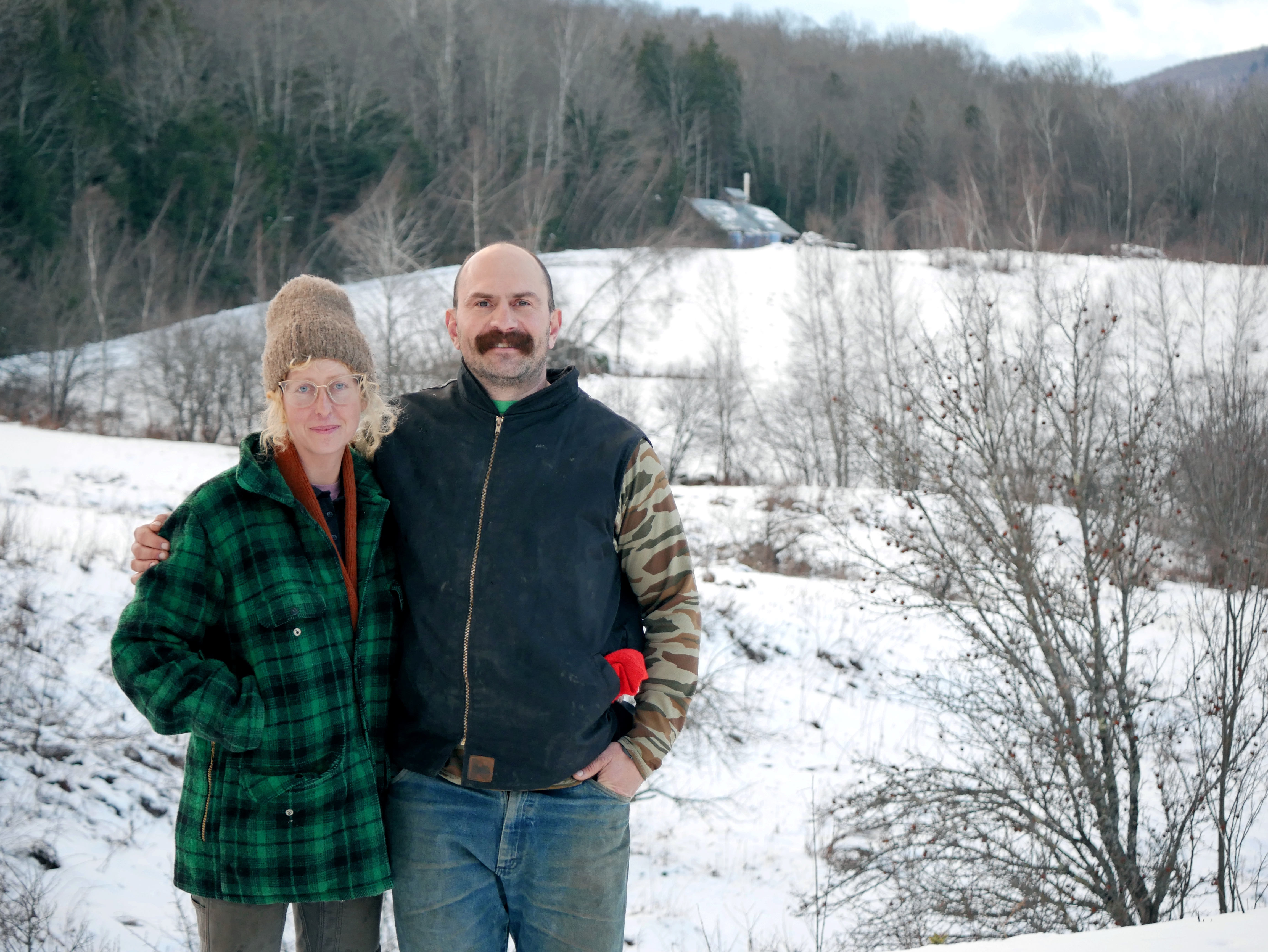 Kari Anderson and Chris Redder stand outside in a field