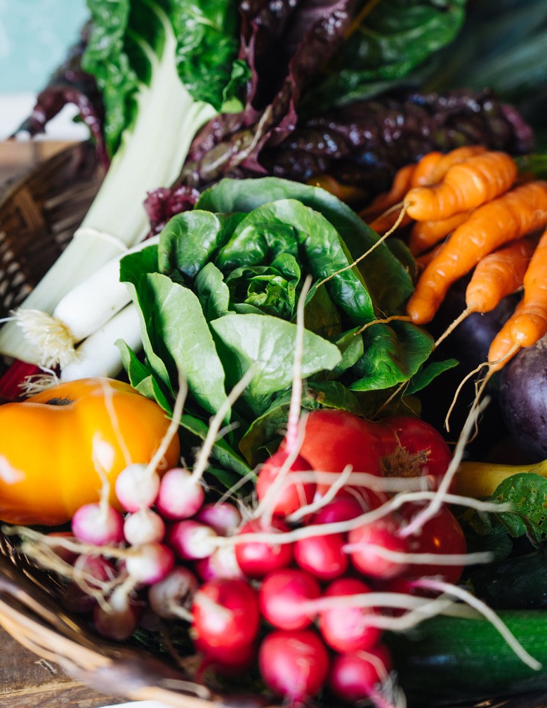 Close up of carrots, cabbage, and assorted vegetables