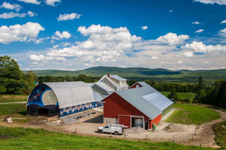 Aerial photo of Jasper Hill Farm with cloud filled sky in background