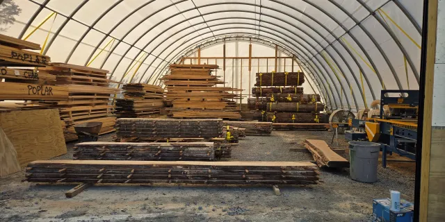 Stacks of wood dry in a shed